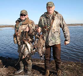 Father and son team of Dwight and Don Reeve with their limits of ducks.